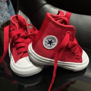 Red and White Comverse high tops